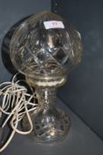 A glass table lamp in form of an oil lamp.