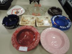 A selection of vintage advertising ashtrays including Carlesberg and Walkers Stout