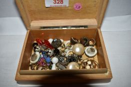 A small treen box containing a selection of earrings including ceramic, marcasite etc