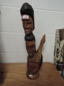 An exotic wood hand carved totem of figure heads