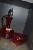A cranberry glass decanter,beaker and footed bowl.