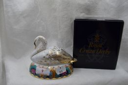 A Royal Crown Derby Swan paperweight, boxed with gold stopper