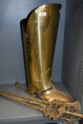A brass coal bucket in the form of a boot and a fire side set.