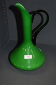 A vintage green glass jug.