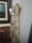 Two Dunelm mill blinds having beige ground with taupe and crimson tulip pattern.