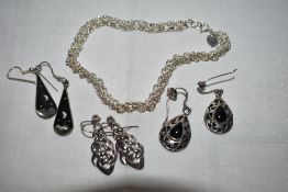 A white metal ankle chain stamped Hong Kong 925 having daisy decoration and three pairs of white