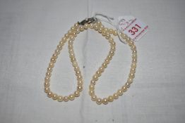 A string of cultured pearls of even form having a white metal box clasp stamped silver, approx 16'