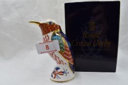 A Royal Crown Derby Hummingbird paperweight, boxed with gold stopper