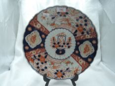 An antique scalloped Imari charger plate with traditional Japanese design