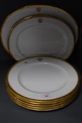 A selection of dinner ware plates and chargers by Copeland having gilt decoration and monogramed