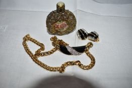 A 1980's style gold plate necklace having a black enamel and diamante central panel with matching