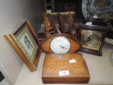 A selection of mantle items including book ends clock and Thorens music box