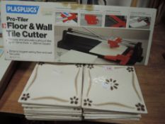A Plasplugs tile cutter in box and some tiles.