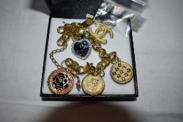 A Swarovski rainbow crystal heart necklace, a costume jewellery gold plated bracelet having Chanel