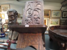 A traditional heavy ethnic wood hand carved African Palavar chair having tree detail to back