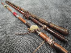A selection of carved and leather work walking or ceremonial sticks