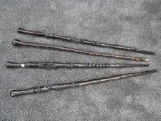 A selection of ethnic tribal walking sticks all hand worked with African designs