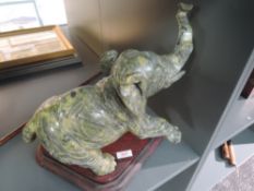 A large heavy set hand carved African elephant possibly soap or similar stone