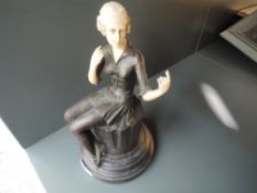 An Art Deco bronze styled figure of a seated dancer approx 25cm high
