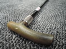 An ebonised walking stick having Hm silver ferrule and bone handle