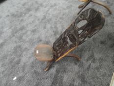A traditional African palavar chair having carved detail to back