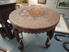 A hand carved Indian table having Elephant head legs and decoration