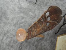 A traditional African palavar chair having carved detail to back of elephants