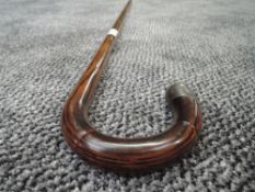 A bent wood walking stick with bamboo style shaft having HM silver tip