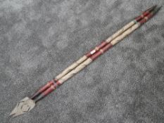A pair of tribal possibly African spears having wrought iron tips measuring 125cm long