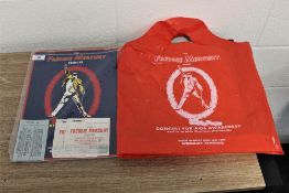 A Freddie Mercury tour programme,ticket and carrier bag.