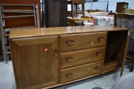 A vintage Ercol sideboard, mid colour, on shepherds castors, dimensions approx. W156 D46 H70cm