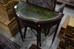 A reproduction demi lune hall table