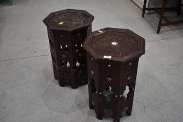 A pair of carved Islamic art style occasional tables, decorated with mother of pearl inlay, damaged