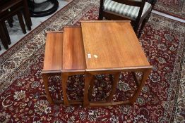 A vintage G plan style teak nest of three tables