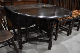 A traditional dark oak gateleg table width approx. 90cm