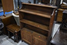 An Arts and Crafts golden oak bookcase, width approx 93cm , height 129cm, sadly no carved mouseman