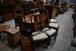A modern Oriental extending dining table and eight (six plus two) chairs, matches bookcase lot 43