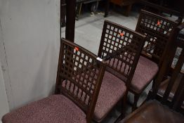 A set of three late Victorian lattice back dining chairs having later moquette upholstered seats