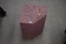 A vintage Lloyd Loom corner linen basket