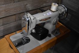 A vintage Seamstress electric sewing machine, in case