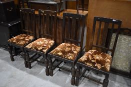 A set of four early 20th Century oak dining chairs