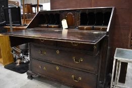 A 19th Century oak bureau, having fitted interior over two over two drawers