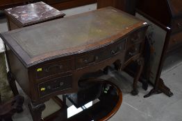 An early 20th Century serpentine front pedestal desk or dressing table, on cabriole legs