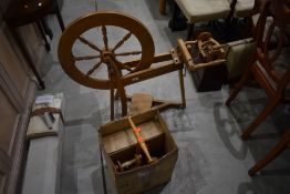 A traditional beech spinning wheel and accesories