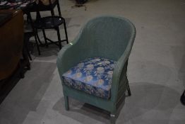 A vintage woven fibre tub chair