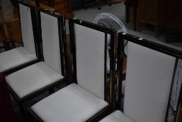 A set of four modern metal (black and gilt) upholstered dining chairs