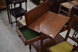 An Arts and Crafts oak tea trolley, labelled for Arthur Simpson Handicrafts of Kendal (circular
