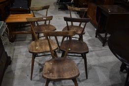 A set of five part stripped Ercol style dining chairs, with double splay spindle and rail back