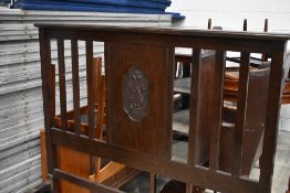 An early 20th Century oak bed frame, width 138cm (4ft6) having carved panel decoration
