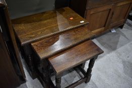 A solid oak nest of three tables